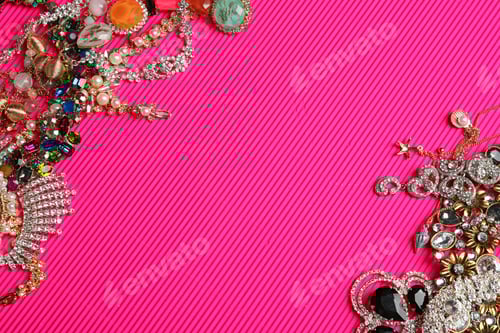 Preview: Frame made of different jewelry on pink background, above view. Space for text