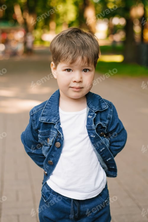 Preview: Portrait of a cute three-year-old boy in jeans in summer in the park