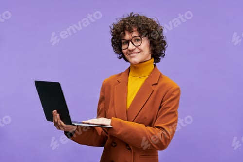 Preview: Happy young successful teacher with laptop looking at camera