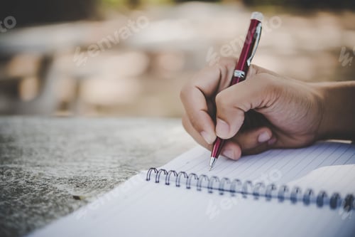 Preview: Man hand writing on his notebook.