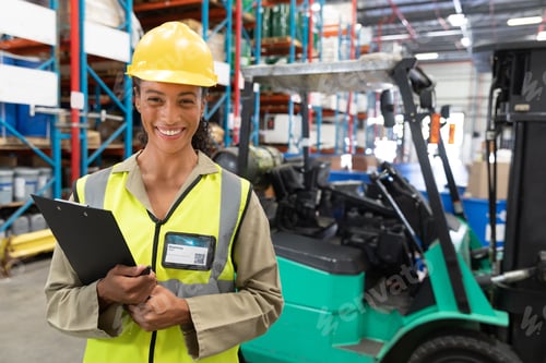Preview: Warehouse shelves are storing cardboard boxes in brightly lit aisle, with green forklift