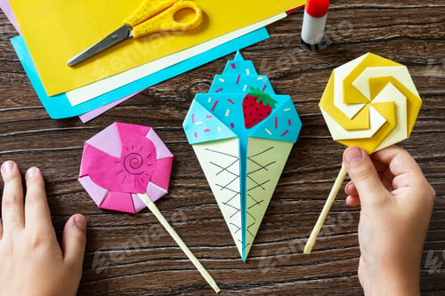 Preview: Funny toy lollipop and ice cream on a wooden table.