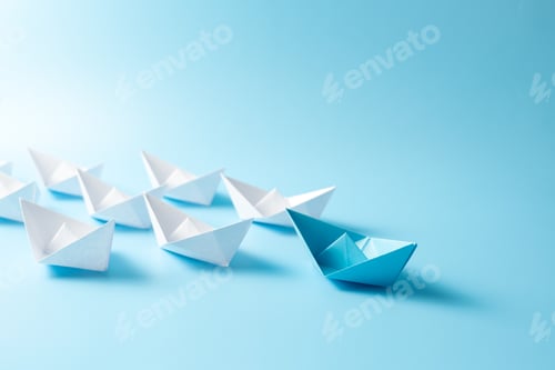 Preview: Leadership concept with blue paper ship leading among white