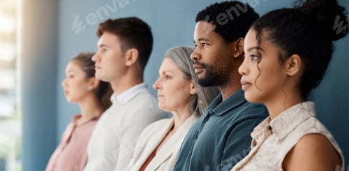 Preview: Group of serious businesspeople sitting in a row in an office together. Faces of business professio