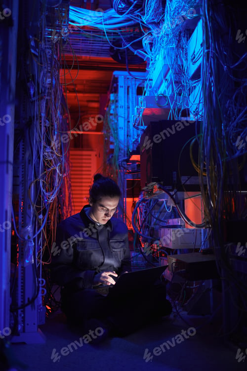 Preview: Technician in Dark Network Room