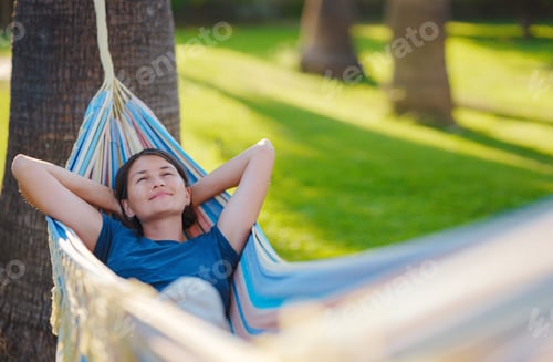 Preview: Relaxed Woman in Hammock on Sunny Day