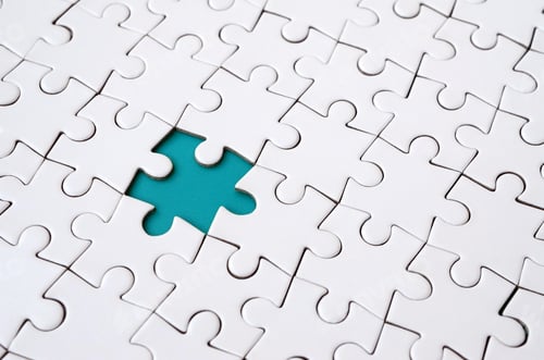 Preview: Close-up texture of a white jigsaw puzzle in assembled state with missing elements
