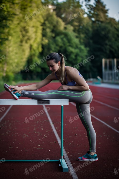 Preview: beautiful sporty girl warming up at the stadium,