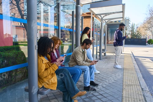 Preview: People using smartphones while waiting at bus stop