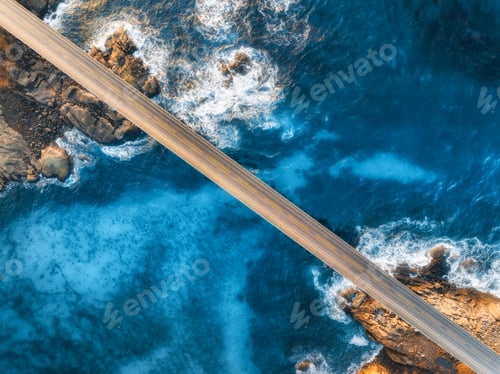 Preview: Aerial view of bridge, sea with waves and stones at sunset