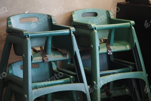 Preview: High chairs for baby stacked in a restaurant corner for storage