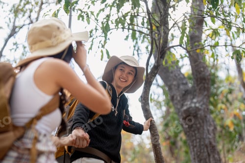 Preview: Lovely couple lesbian woman with backpack hiking in nature. Loving LGBT romantic moment in