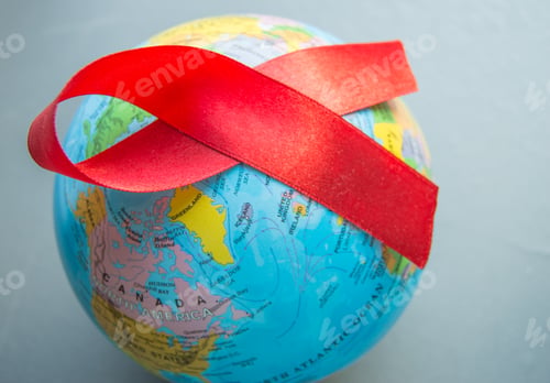 Preview: World AIDS day 1 December, close-up of world globe with red ribbon