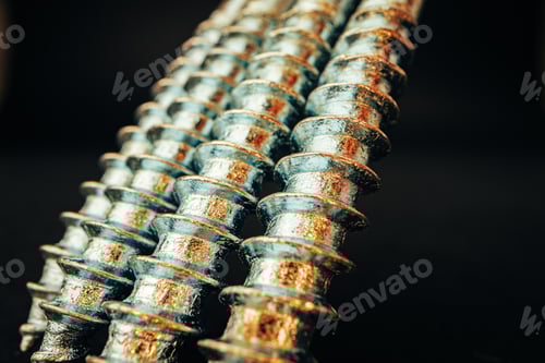 Preview: Many metal screws on concrete close up