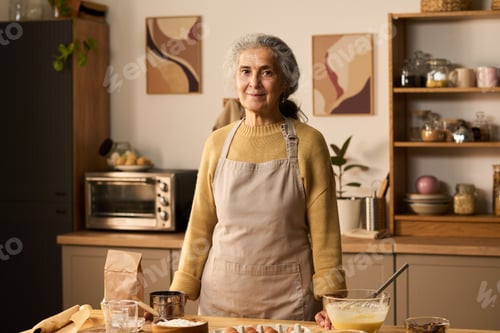 Preview: Portrait of Senior Woman Smiling While Preparing Dough in Kitchen