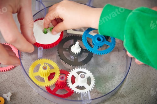 Preview: Hands assembling plastic cogwheels