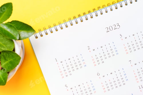 Preview: Calendar for 2023 on a yellow background close-up, planning concept.