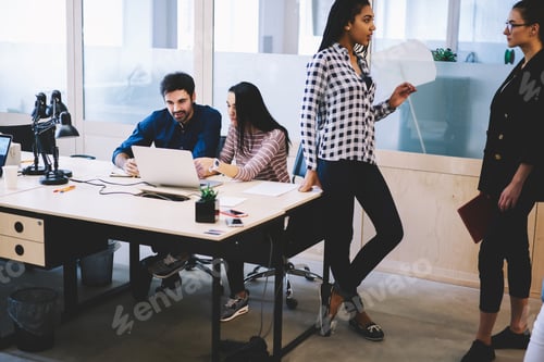 Preview: Diverse colleagues working on project together in office