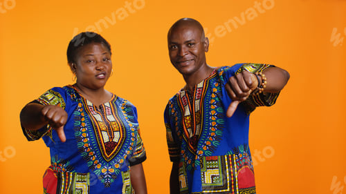 Preview: Ethnic man and woman showing thumbs down symbol