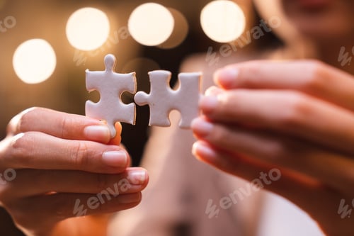 Preview: Business person team work holding jigsaw to connecting successful puzzle piece