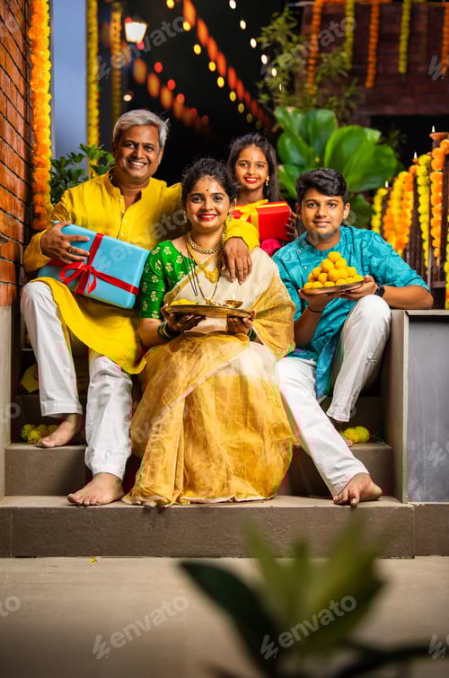 Preview: Happy Indian family with kids celebrating Diwali, holding Pooja thali, sweets, gifts on the stairs