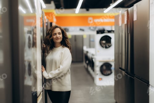 Preview: Young Woman Shopping in an Electronics Store for Home Appliances
