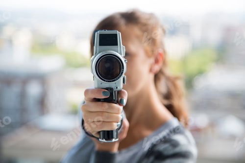 Preview: Young woman with vintage camera