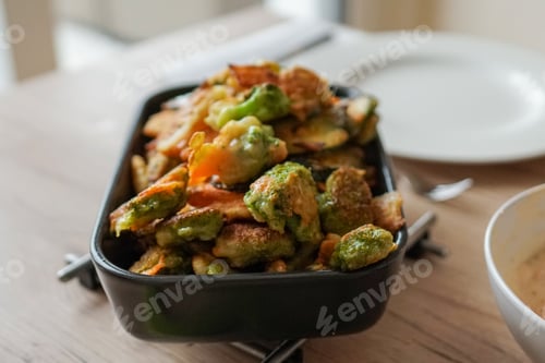 Preview: Closeup of baked vegetables on a ceramic dish served on a table for dinner