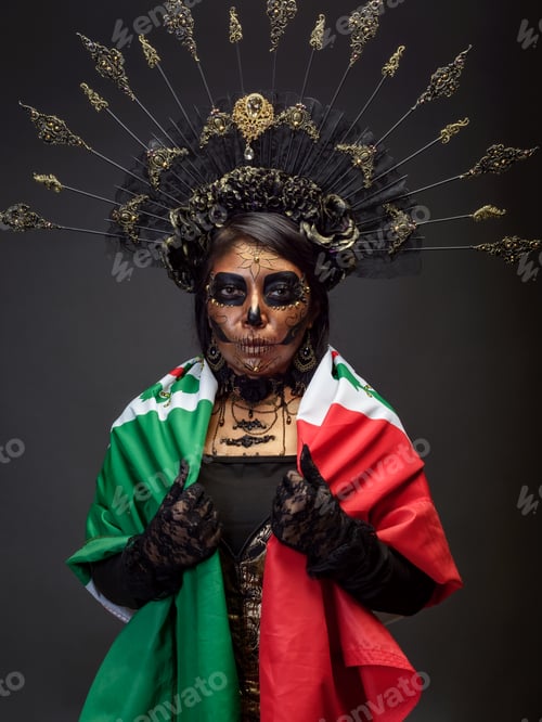 Preview: Studio portrait of a woman in elaborate Catrina makeup and headdress with mexican flag.