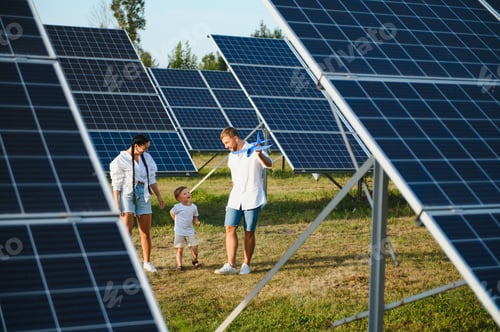 Preview: Happy family near solar panels. Alternative energy source