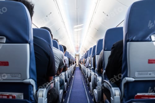 Preview: Passengers traveling by a plane, shot from the inside of an airplane