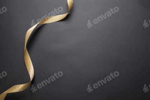 Preview: Golden ribbon curl on black color background. Minimal card template