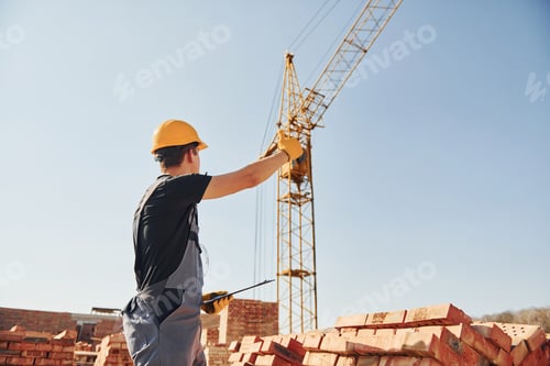Preview: Construction worker in uniform and safety equipment have job on building