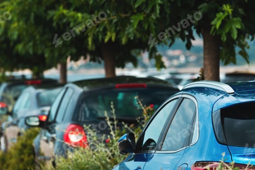 Preview: Parked cars on parking lot with trees