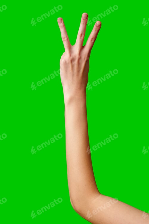 Preview: Human Hand Displaying the Number Three Against a Solid Green Background