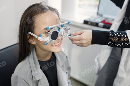 Preview: Girl doing eye test checking examination with optometrist