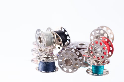 Preview: Messy metal thread bobbins isolated on white background