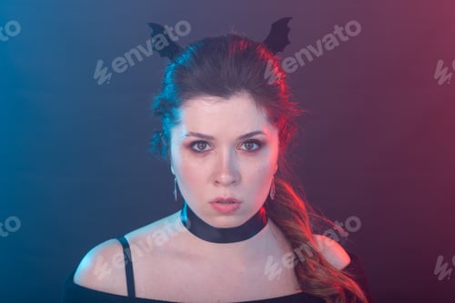 Preview: Halloween, holidays and carnival concept - vamp woman in collar and bat's ears in gothic style