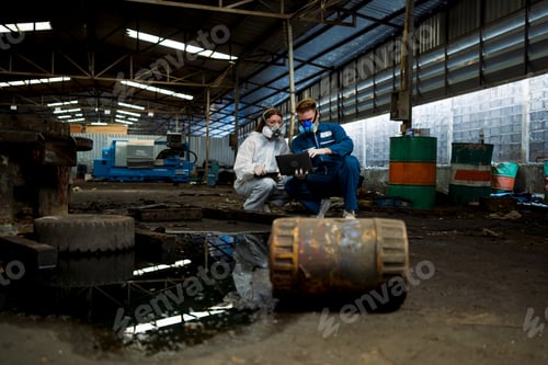 Preview: Tanks of dangerous chemicals in factories. Teams of workers in protective suits