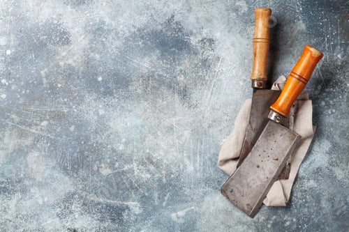 Preview: Butcher. Vintage meat knives over stone table