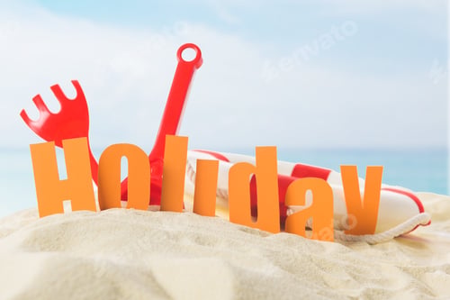 Preview: Beach toys and Holiday inscription in sand on blue sky background