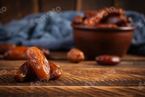Preview: Dried date fruit in bowl on wooden background. Delicious dates fruit