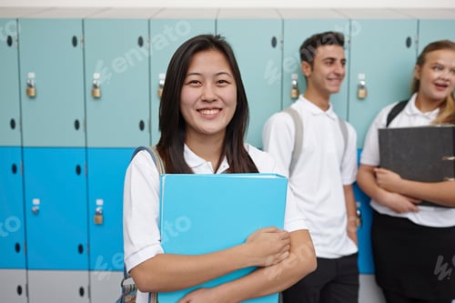Preview: Portrait of teenage schoolgirl next to lockers
