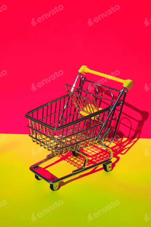 Preview: Empty shopping trolley cart on colorful orange yellow background. Copy space for your text. Online
