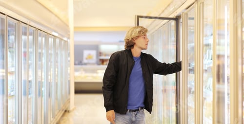 Preview: Man Choosing Frozen Food From A Supermarket Freezer
