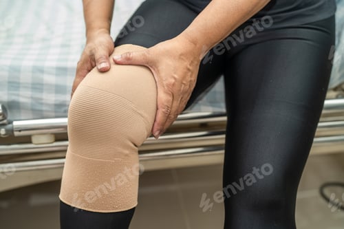 Preview: Asian lady woman patient touch and feel pain her knee, healthy medical concept.