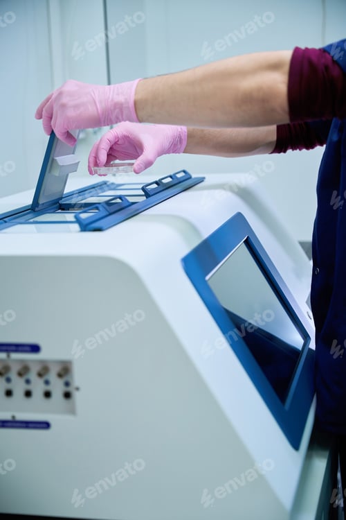 Preview: Gloved hand operating control panel on cryopreservation unit
