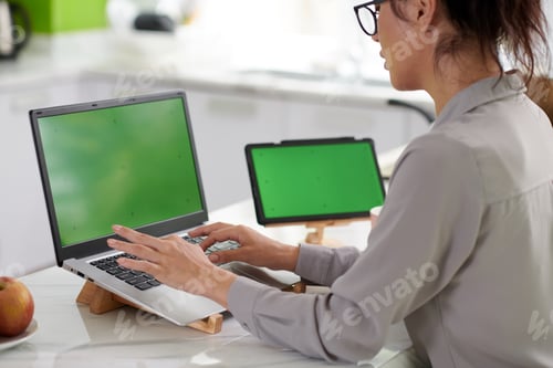 Preview: Cropped shot of young female freelancer typing on laptop keypad