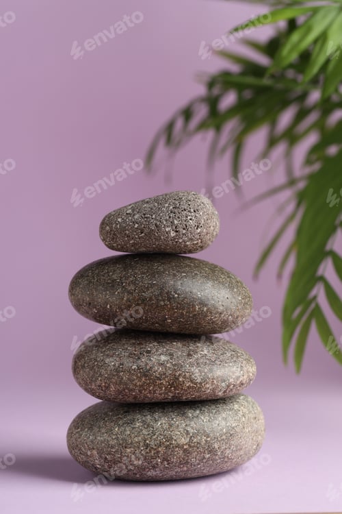 Preview: Stack of rocks on lilac background. Harmony and life balance