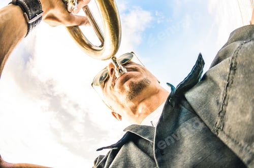 Preview: Artist performing trumpet solo jazz against sky